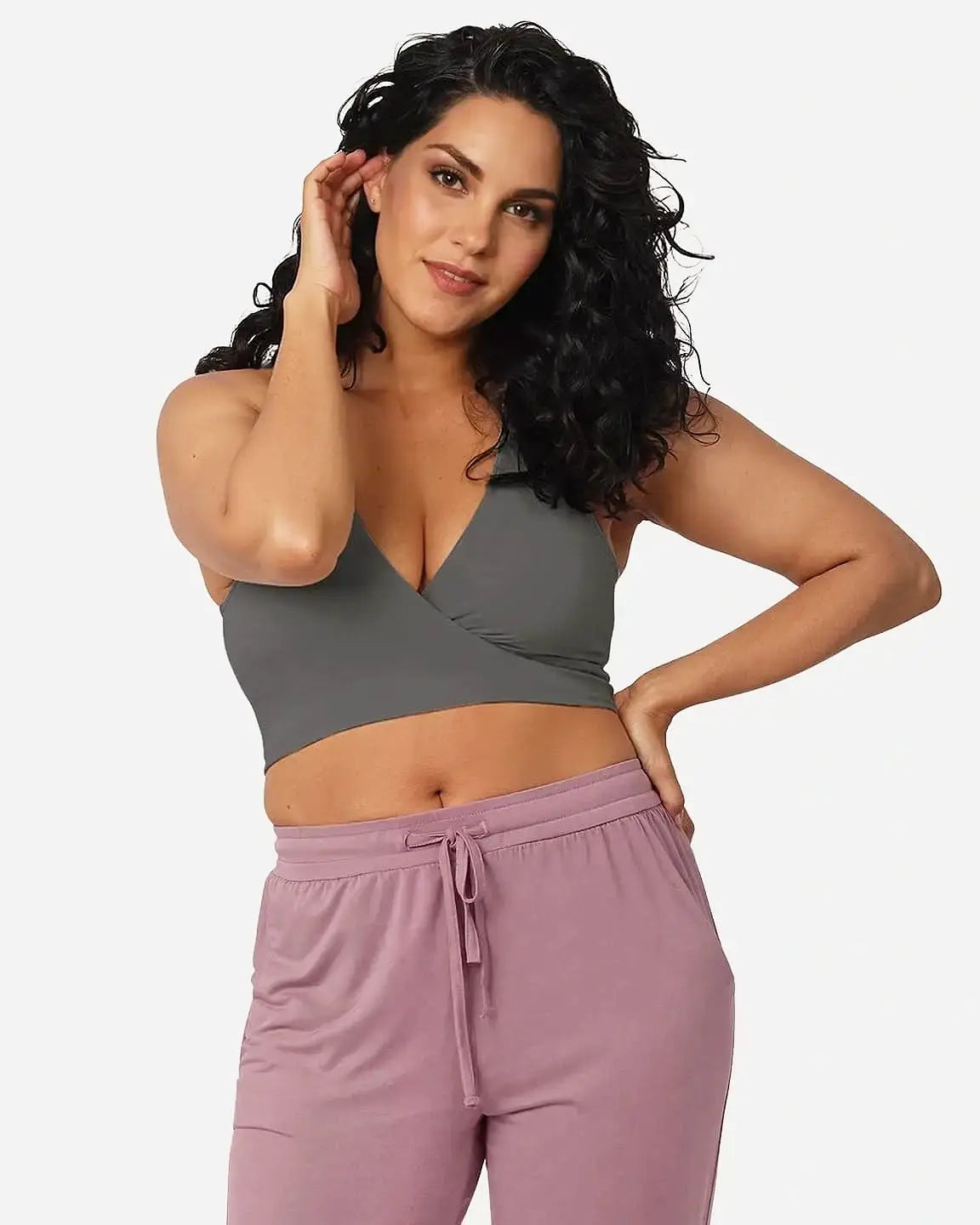 Woman in a soft gray wire-free nursing bra with a crossover design and pink drawstring pants.