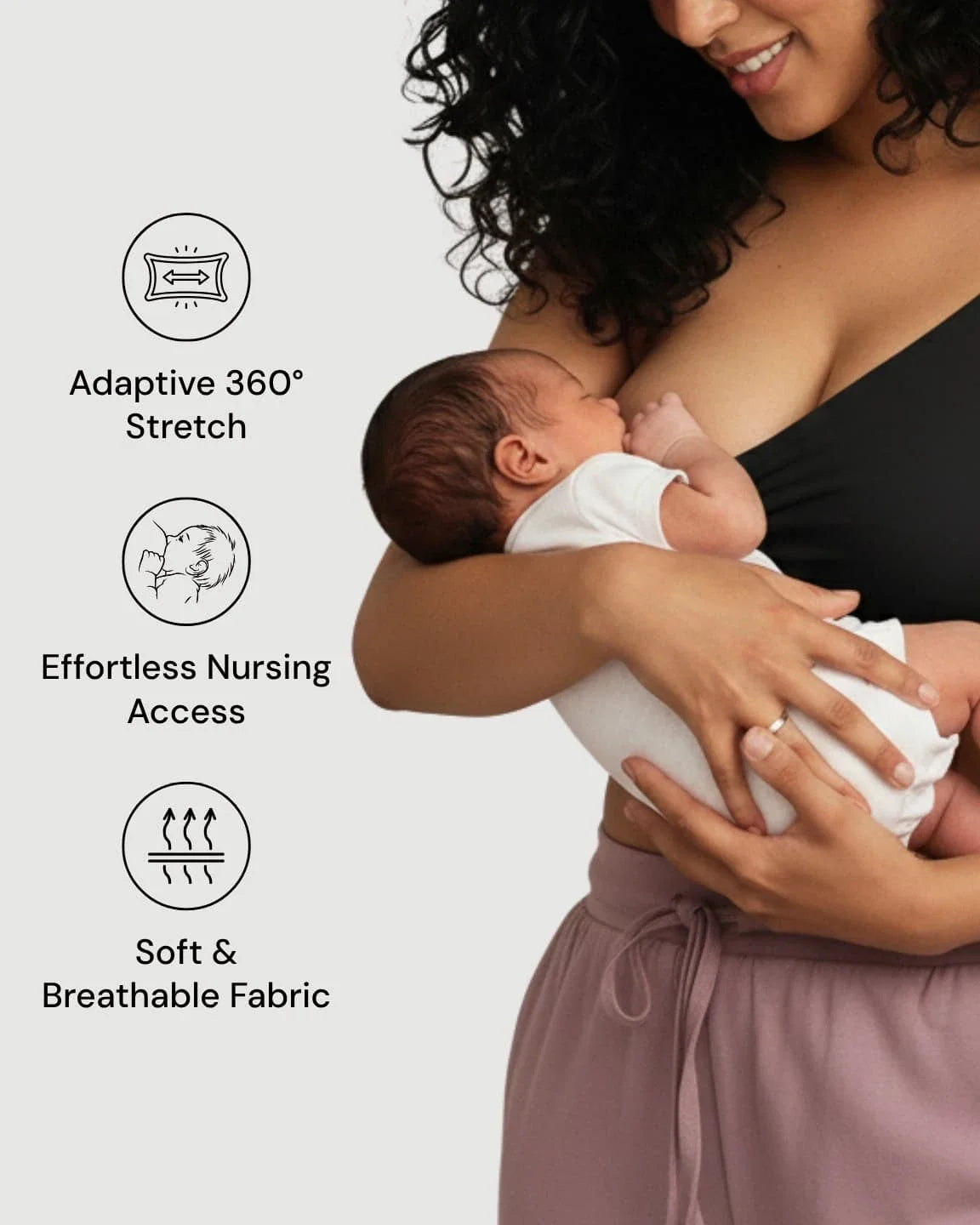Woman in a black wire-free nursing bra breastfeeding a baby, highlighting adaptive stretch and effortless access.