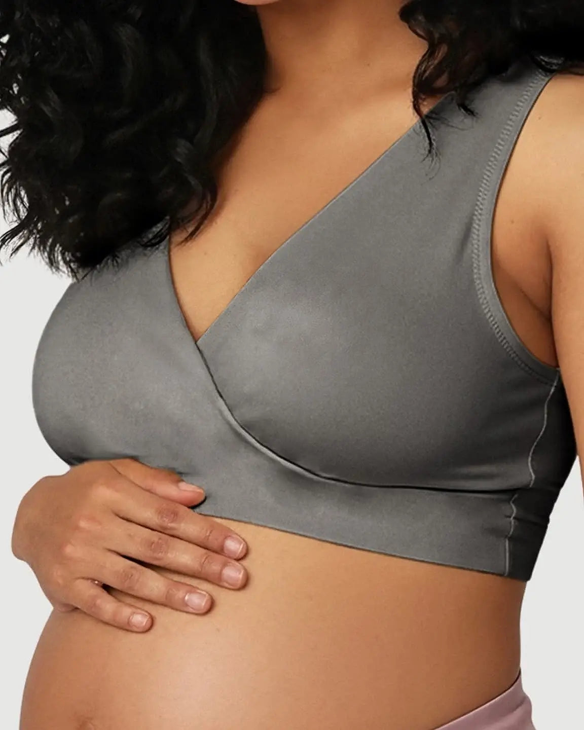 Pregnant woman wearing a gray, soft cotton, wire-free nursing bra with a seamless, pull-aside design.