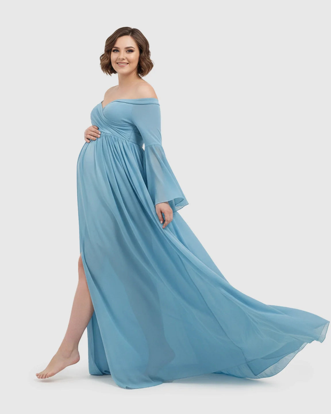 Smiling pregnant woman in a flowing blue chiffon off-shoulder gown with bell sleeves and a long train.