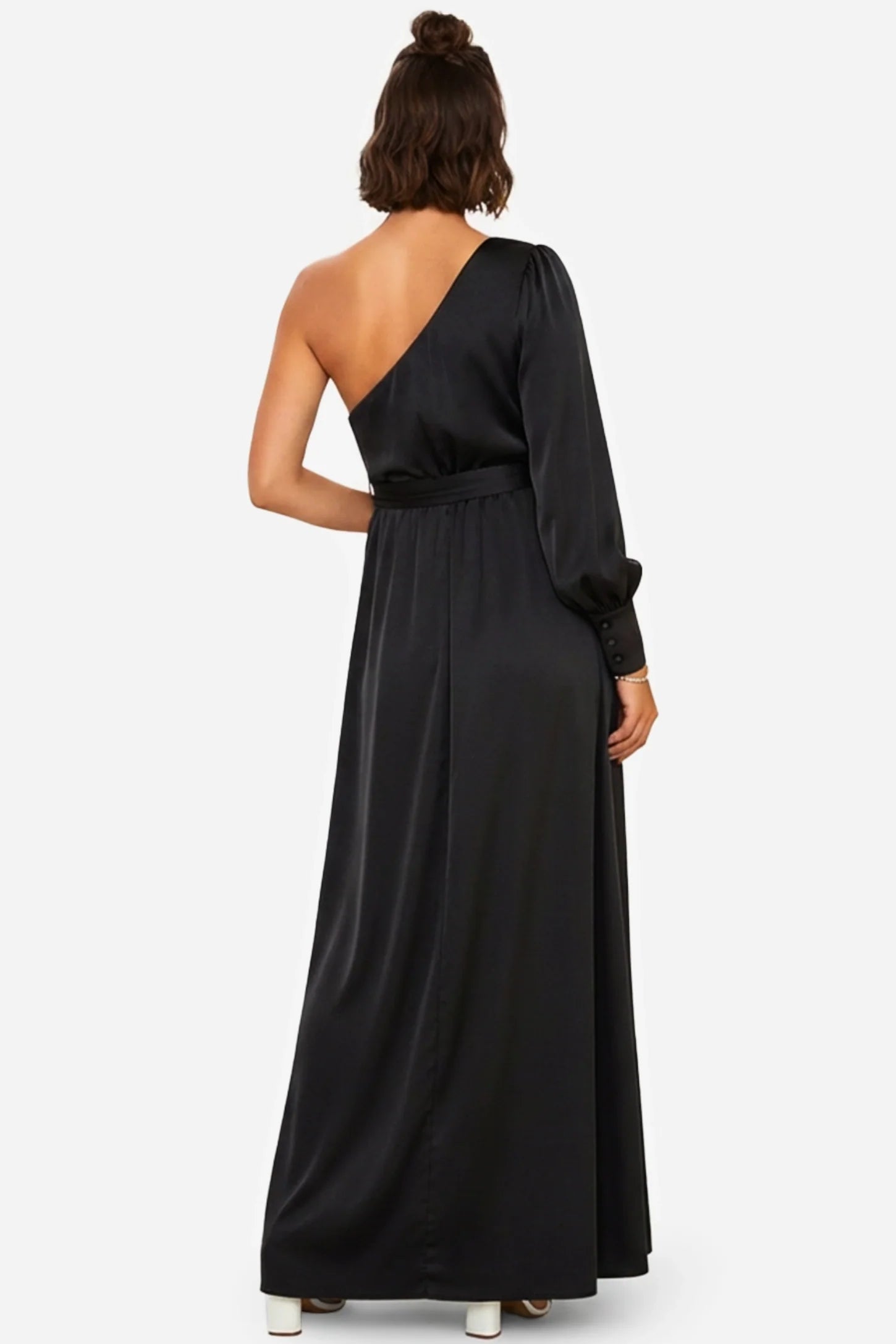 Elegant black satin one-shoulder maternity maxi dress with long sleeve, tie-waist, and flowing silhouette.