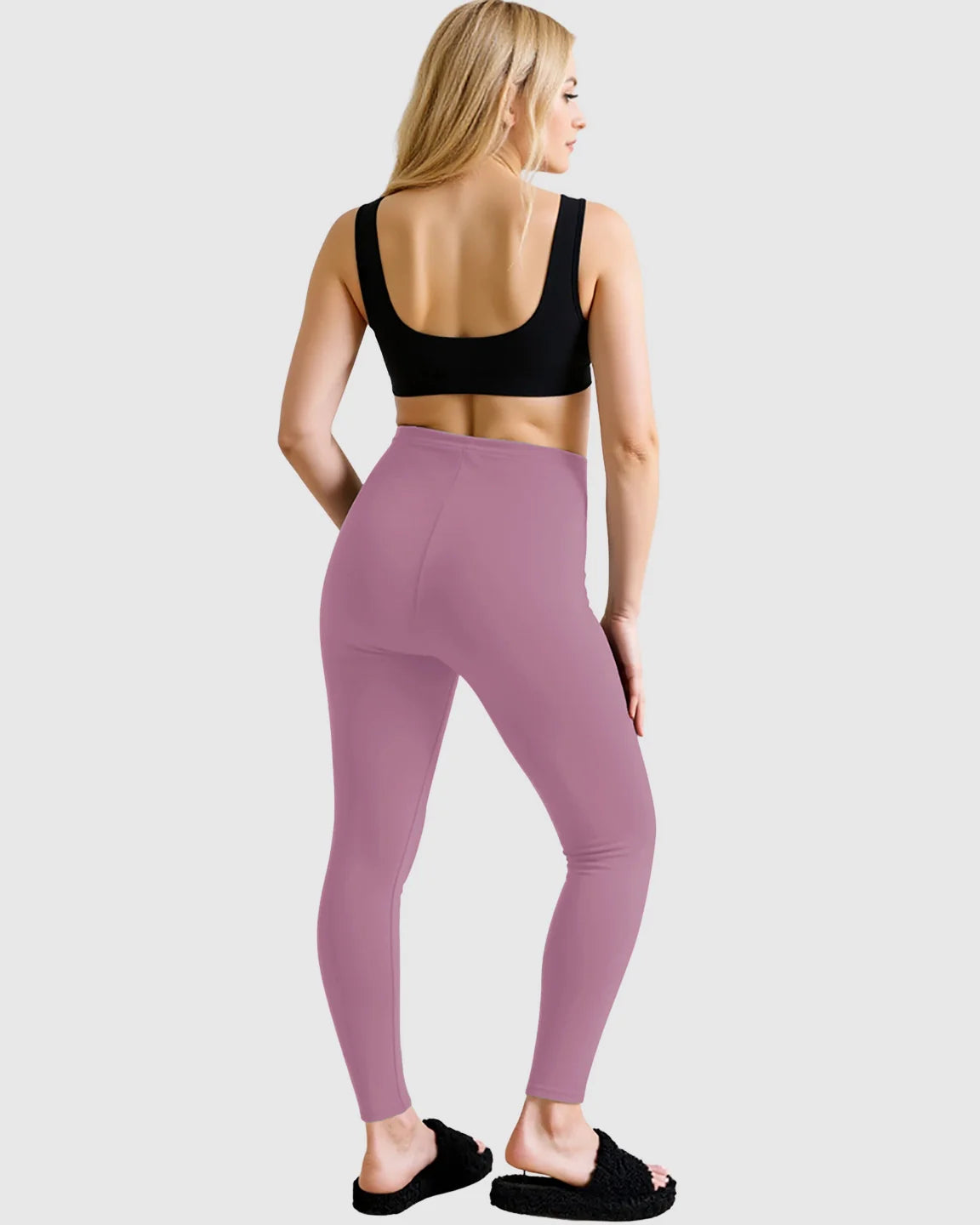 Woman from behind wearing high-waist mauve maternity leggings and a black sports bra.