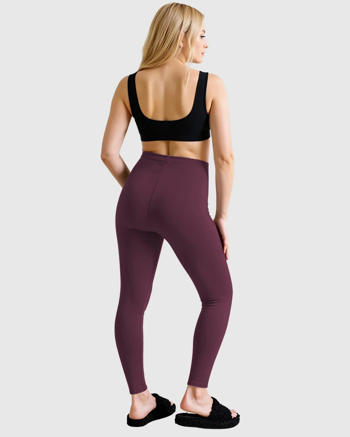 Woman from behind wearing Bump Society plum high-waist sculpting maternity leggings and a black sports bra.