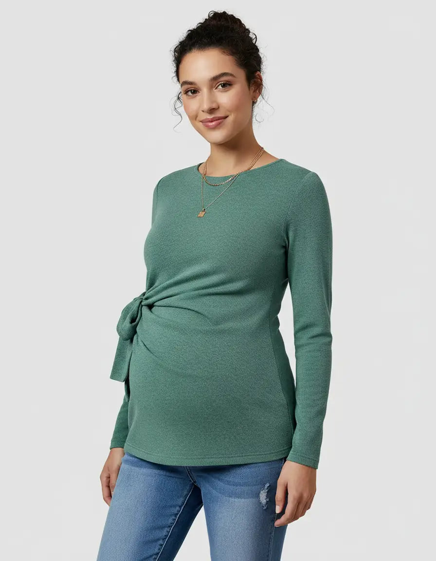 Green long-sleeve maternity top with adjustable side-tie detail, worn by a smiling woman.