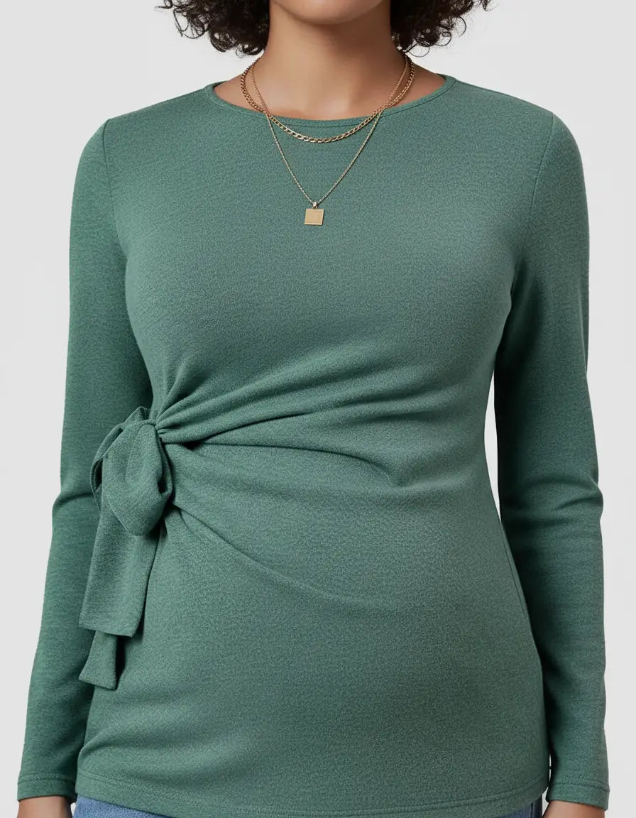 Green long-sleeve maternity top with a side-tie knot detail and a gold layered necklace.