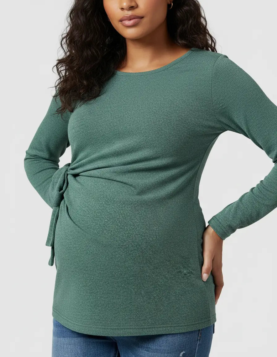 Green long-sleeve maternity top with adjustable side-tie detail, soft ribbed fabric, and relaxed fit.