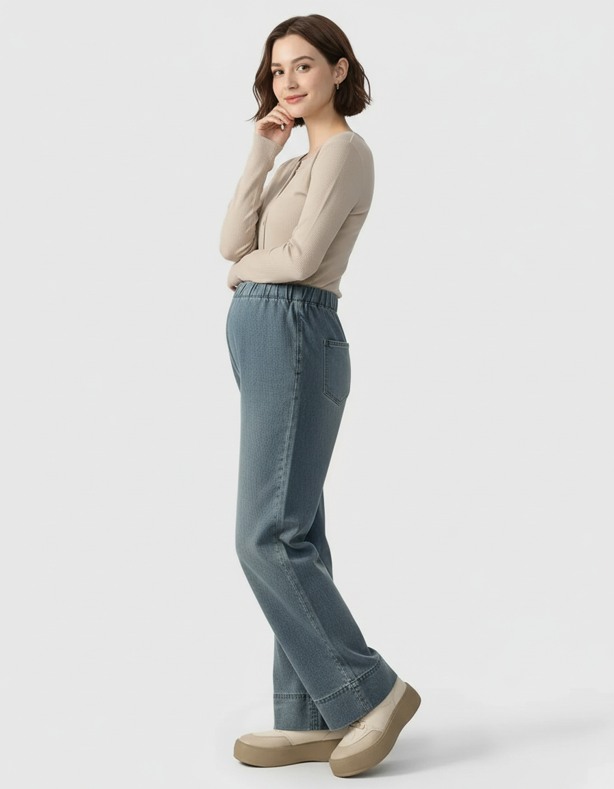 Smiling woman in light wash wide-leg maternity denim pants with an adjustable waist.
