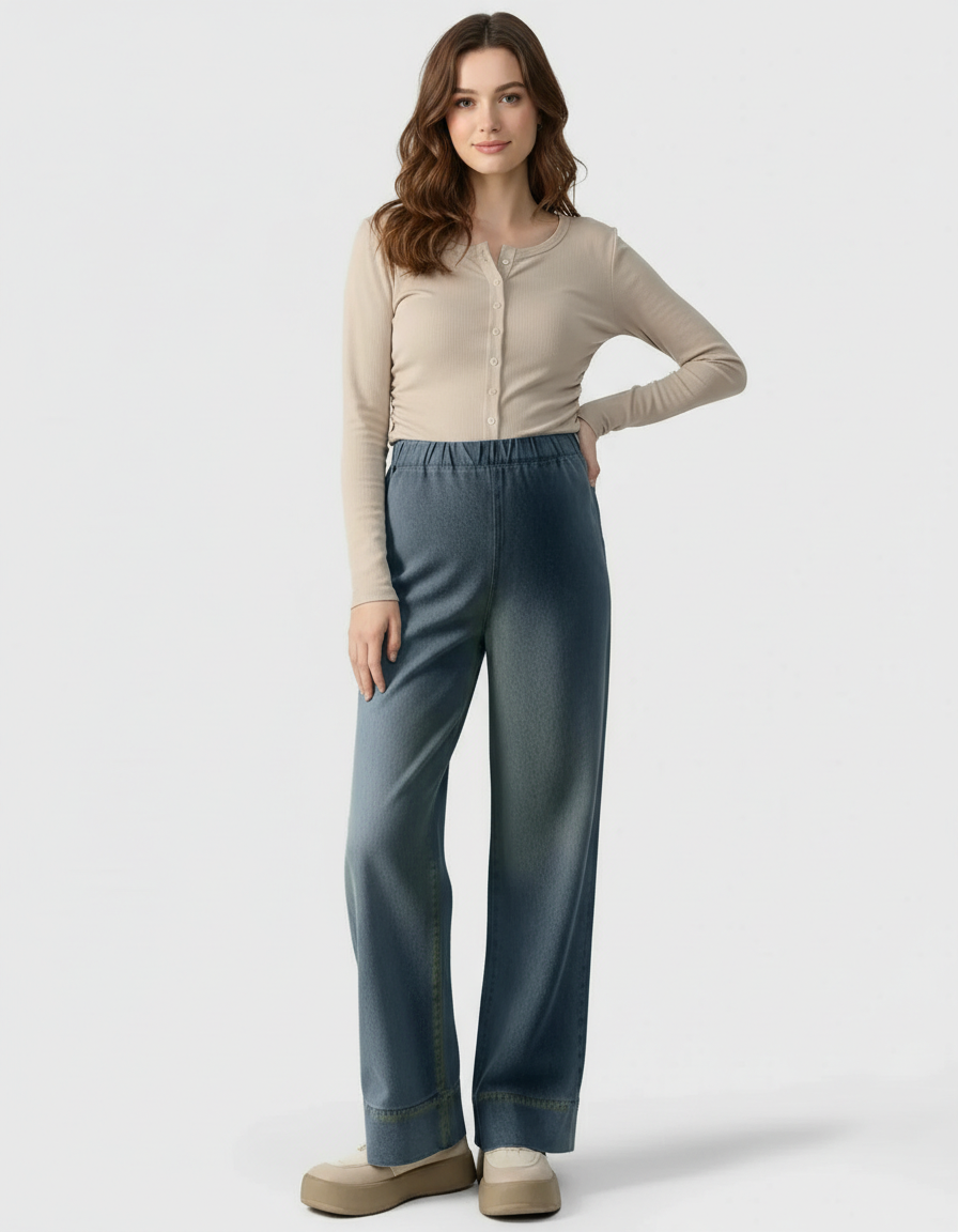 Woman wearing adjustable waist, wide-leg maternity denim pants with a beige ribbed long-sleeve top.