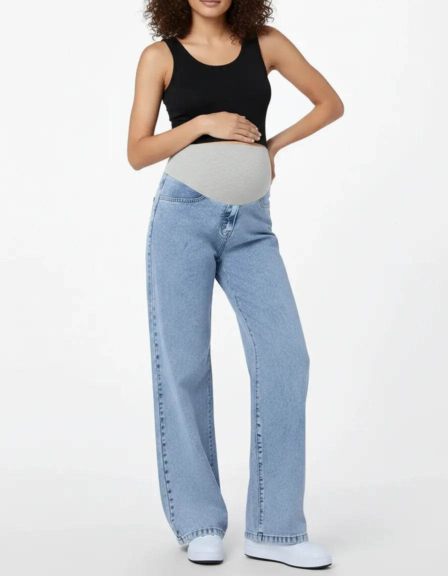 Pregnant woman in light wash wide-leg maternity jeans with a grey adjustable waistband and a black tank top.