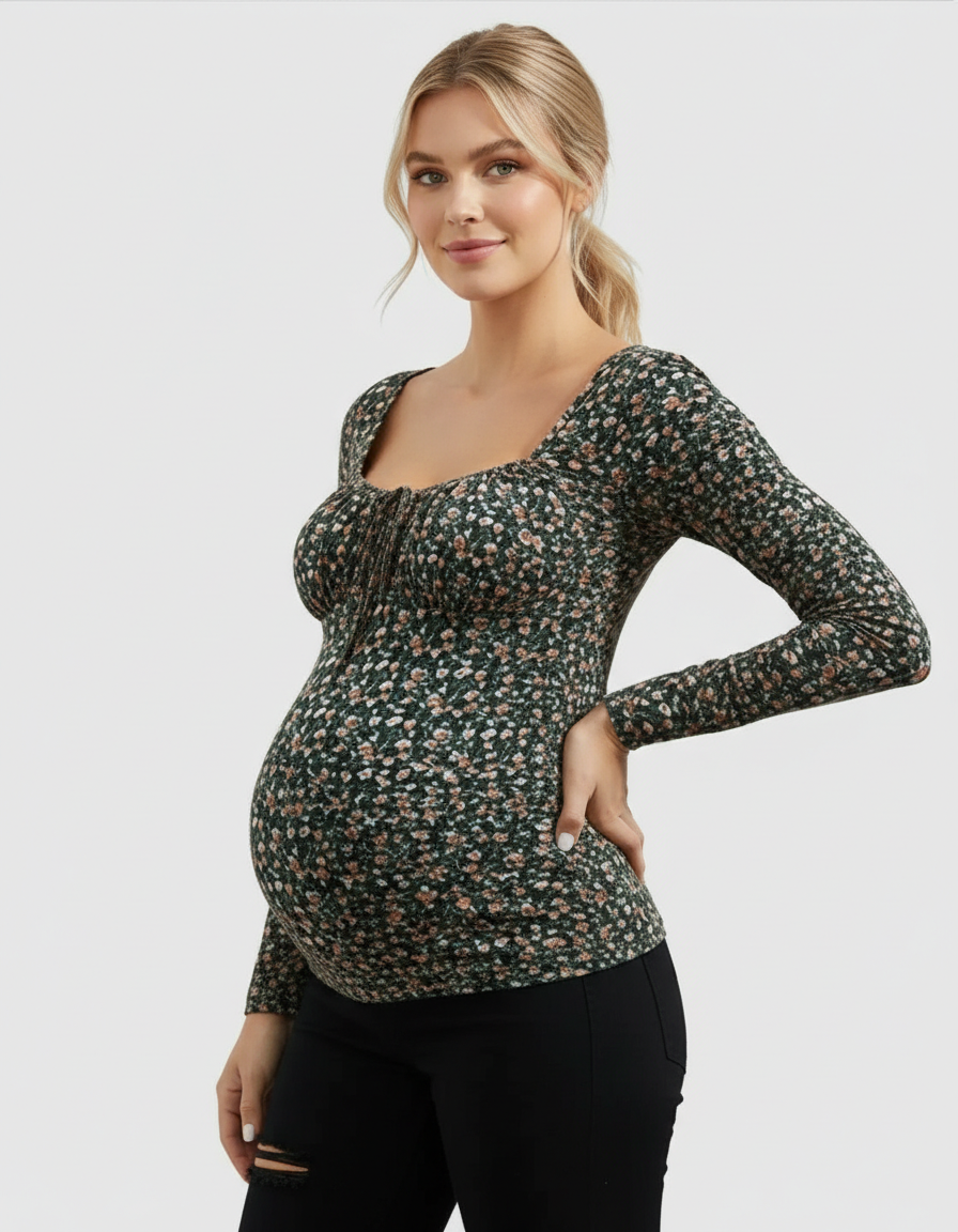 Pregnant woman in a dark green floral ruched tie-front slim-fit maternity top with long sleeves.