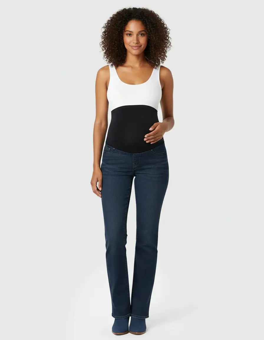 Dark wash classic high-waist flared-leg maternity jeans with an over-belly panel on a smiling model.