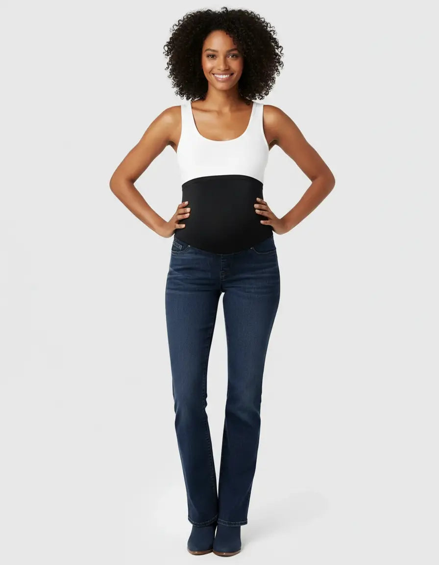 Smiling woman wearing dark wash, high-waist, flared-leg maternity jeans with an over-belly panel.