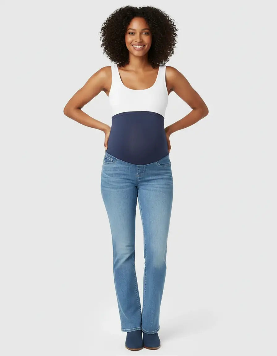 Smiling pregnant woman wearing light wash classic high-waist flared-leg maternity jeans with a navy over-belly panel.