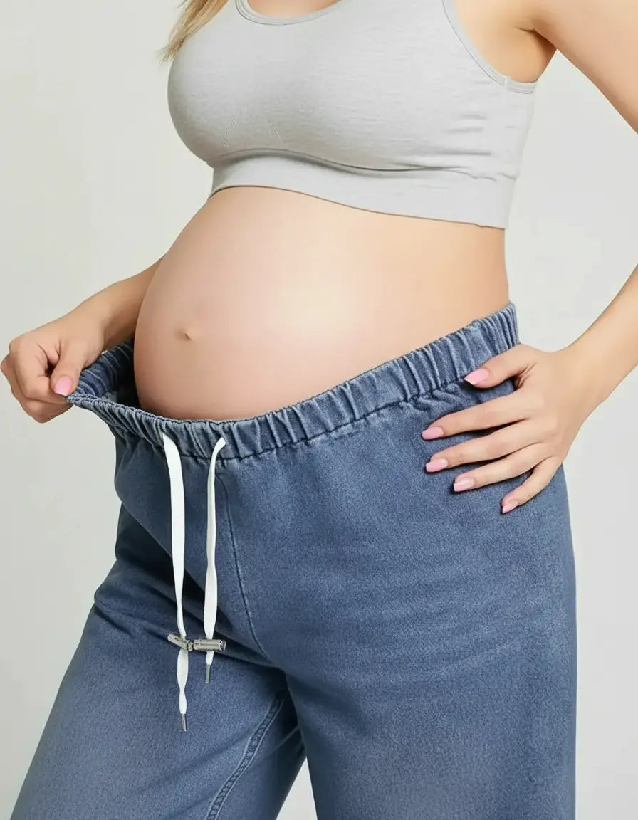 Pregnant woman in gray bra and blue drawstring wide-leg maternity jeans, showing relaxed fit.