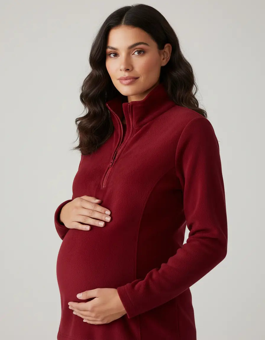 Maternity model in a red fleece half-zip long sleeve top with a stand collar, highlighting a comfortable fit.