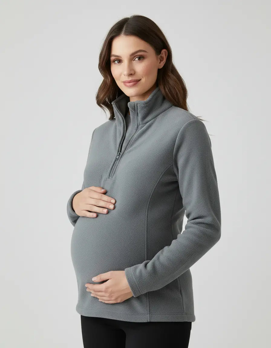 Maternity model in a gray fleece half-zip long sleeve top with a stand collar, designed for comfort.