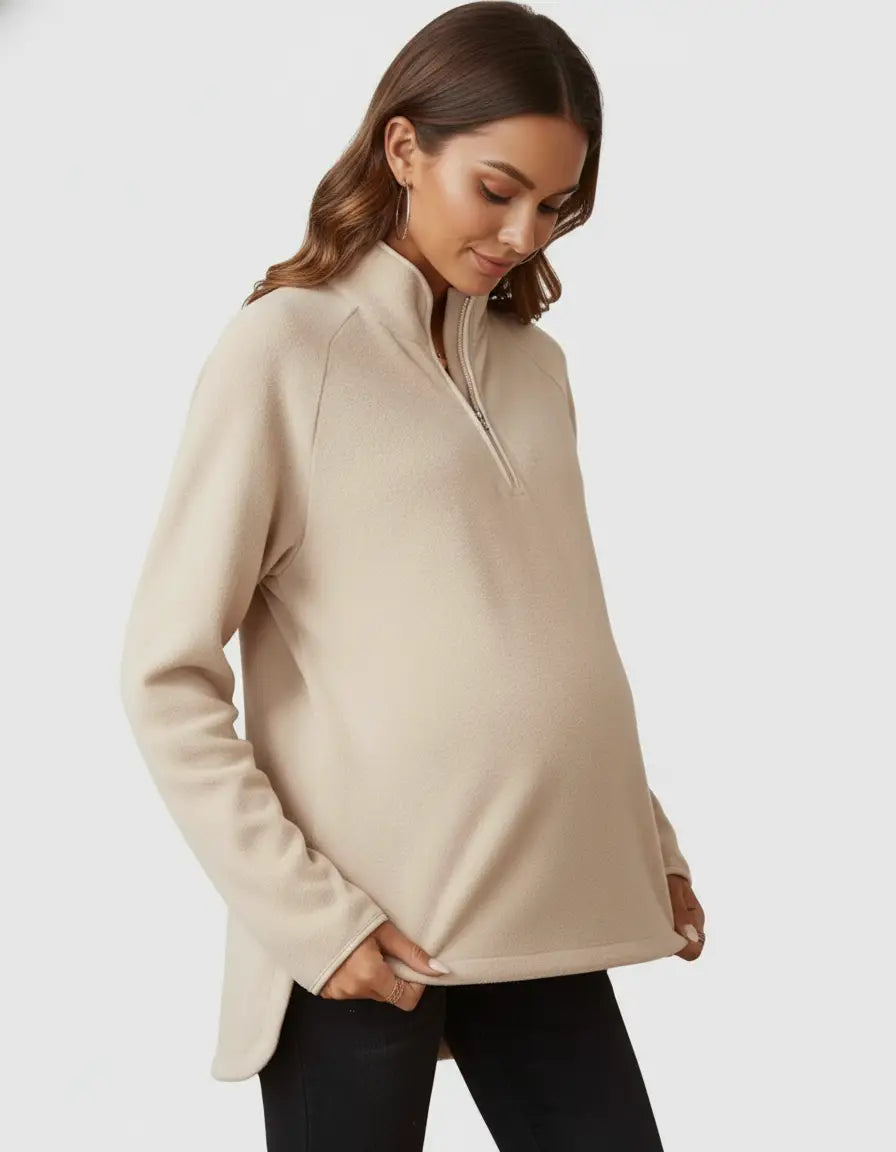Beige soft knit half-zip long sleeve maternity top with stand collar and relaxed fit.