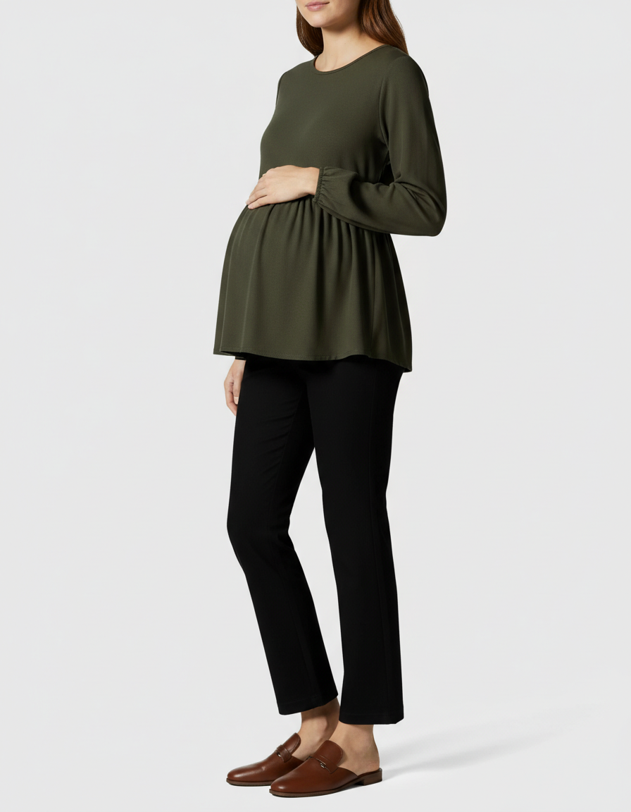 Pregnant woman in olive green long-sleeve maternity top and black high-waist kick flare pants.