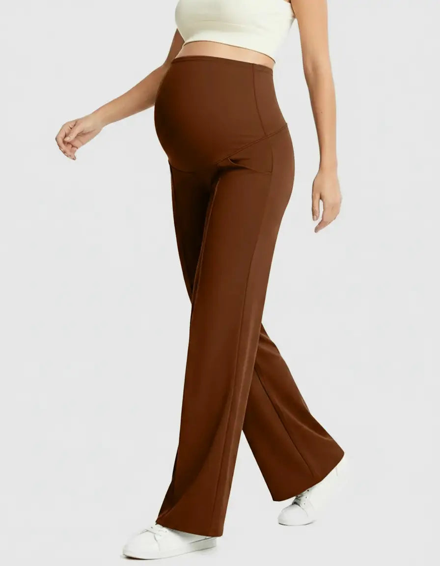 Pregnant woman wearing high-waisted, relaxed-fit brown maternity pants with a supportive belly panel.