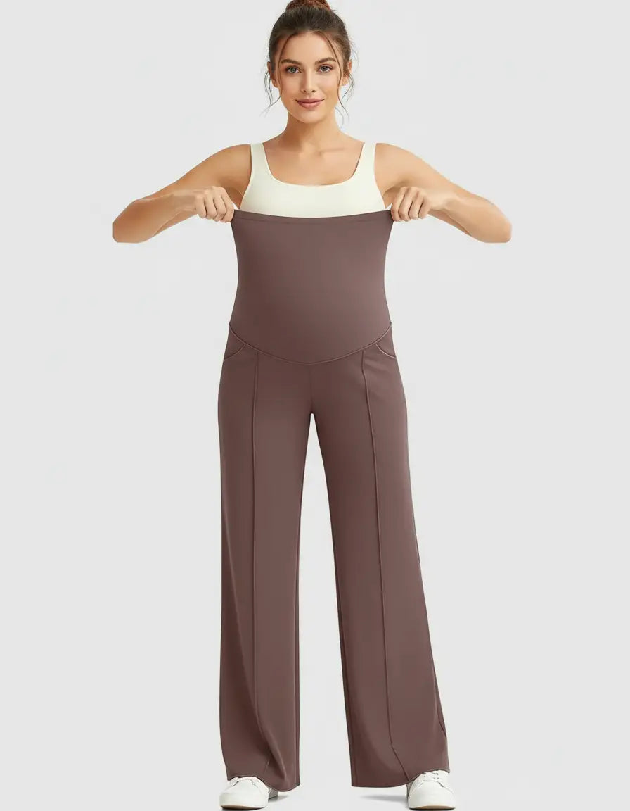 Woman modeling brown high-waist maternity pants with a relaxed fit and a supportive belly panel.
