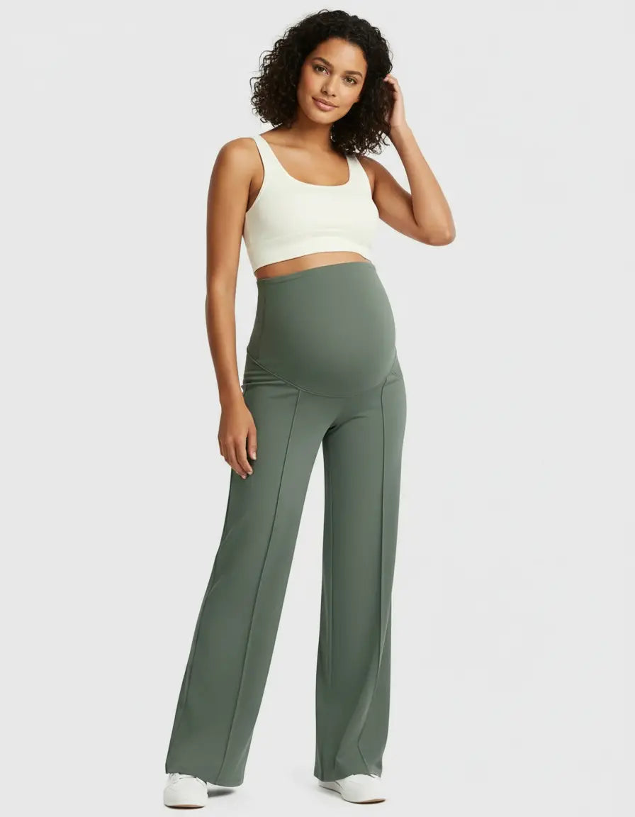 Woman in olive green high-waist maternity pants with a relaxed fit and a cream crop top.