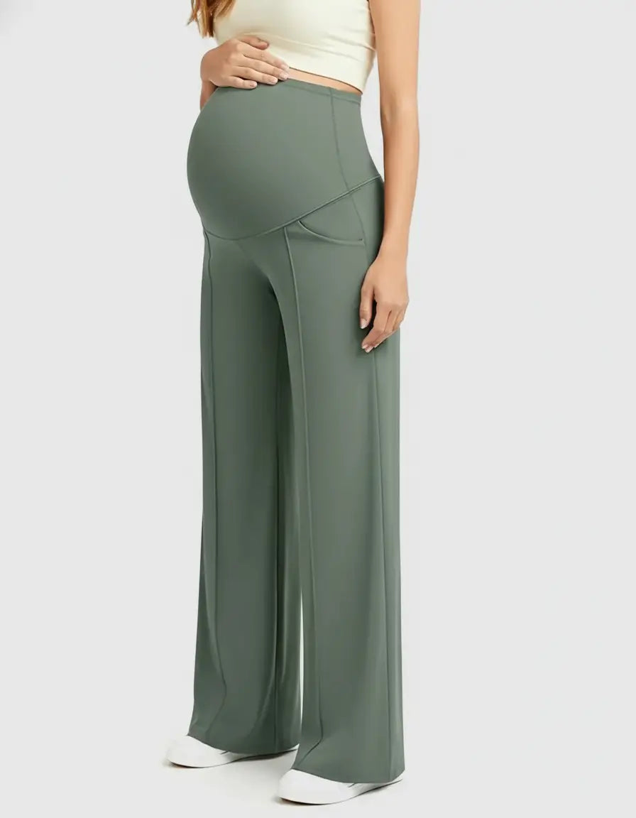 Pregnant woman wearing high-waist, relaxed-fit sage green maternity pants with a wide leg and belly panel.