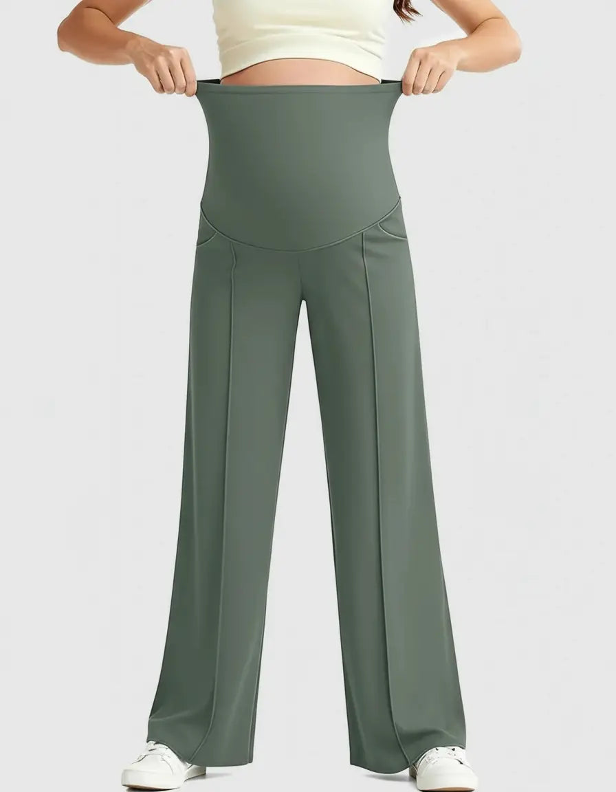 Woman wearing olive green high-waist maternity pants with a relaxed, wide-leg fit and front seam details.