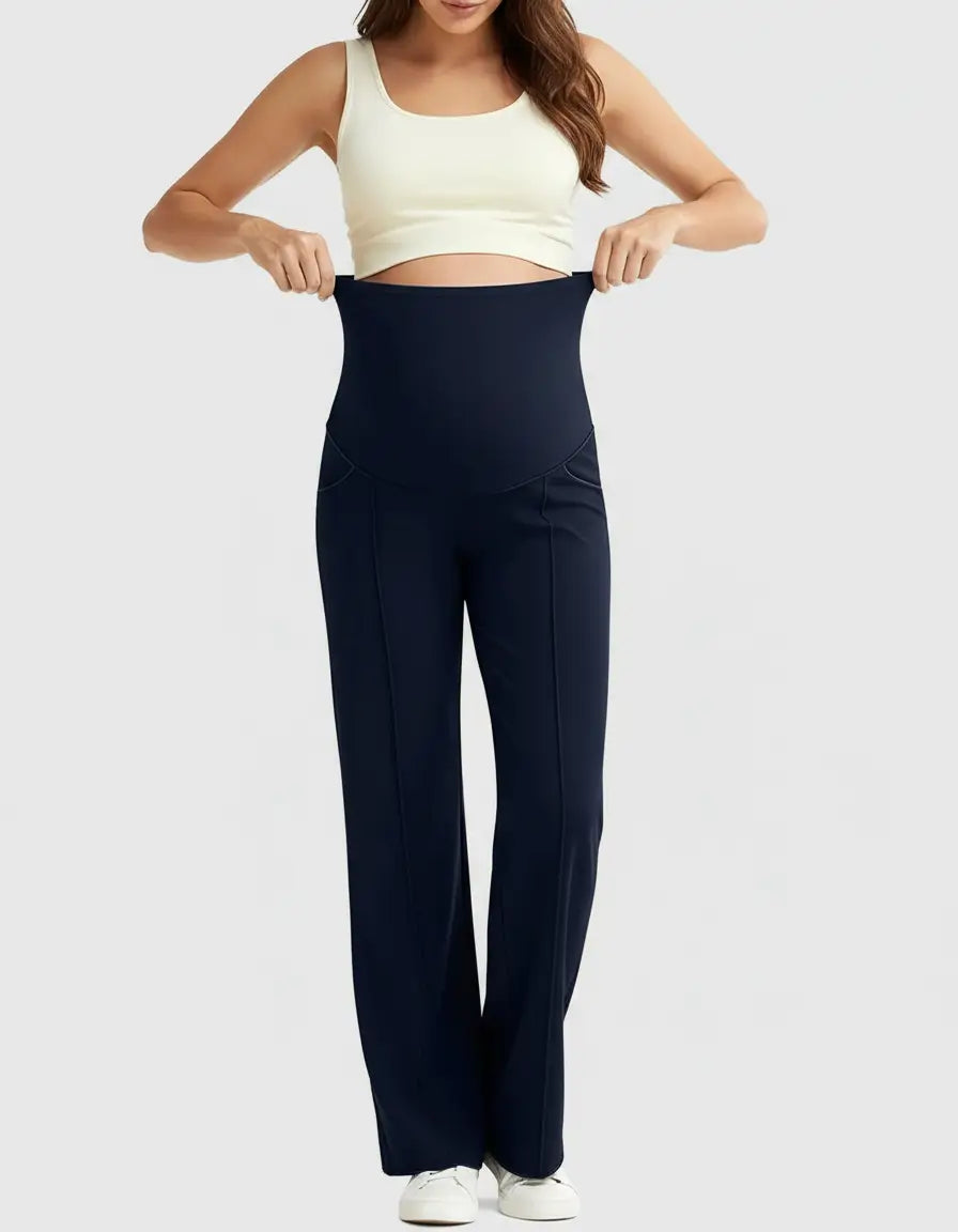Woman wearing navy high-waist maternity pants with a relaxed fit, showcasing the stretchy waistband.