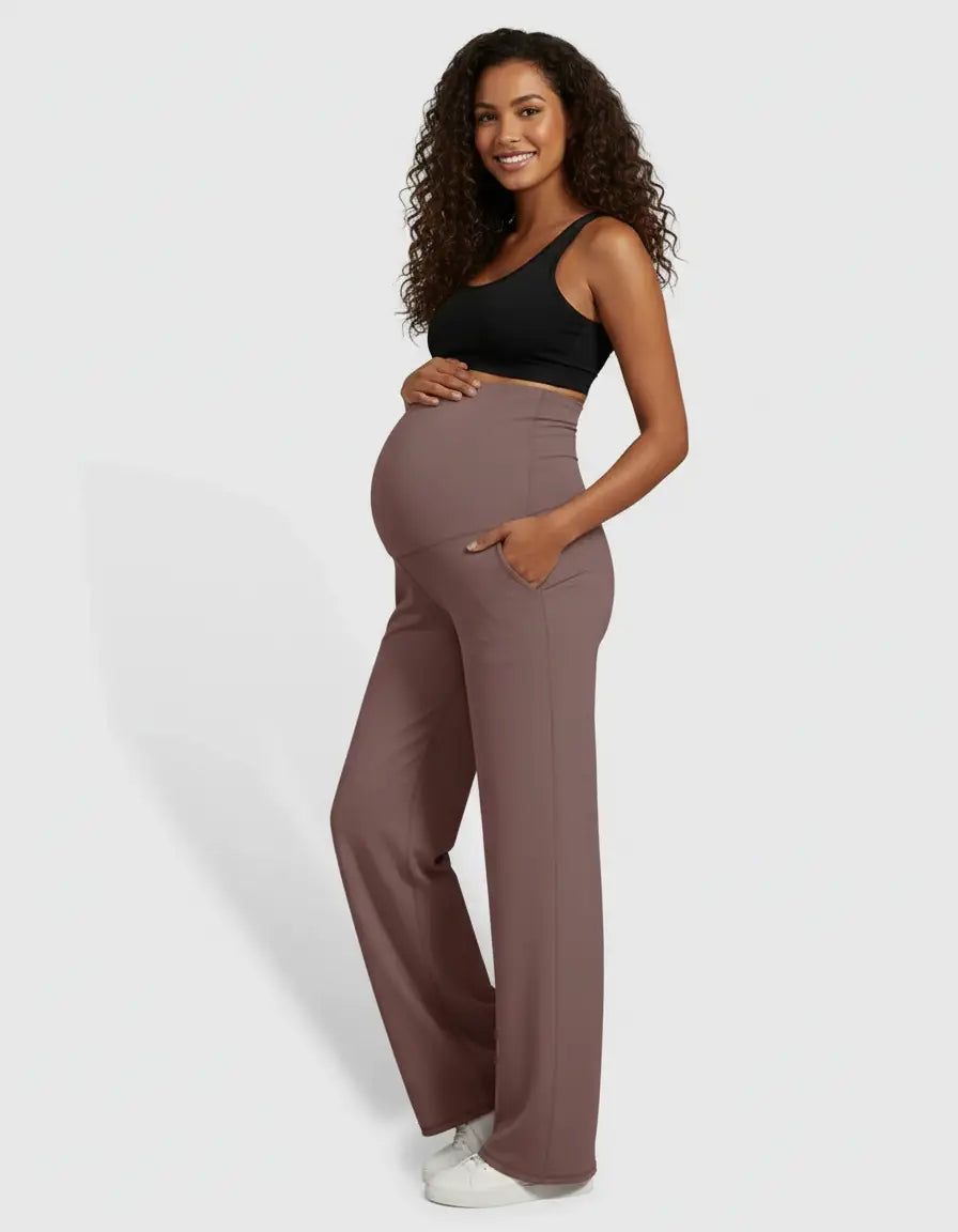Smiling pregnant woman in high-waist, straight-leg maternity pants in a soft mauve color with pockets.