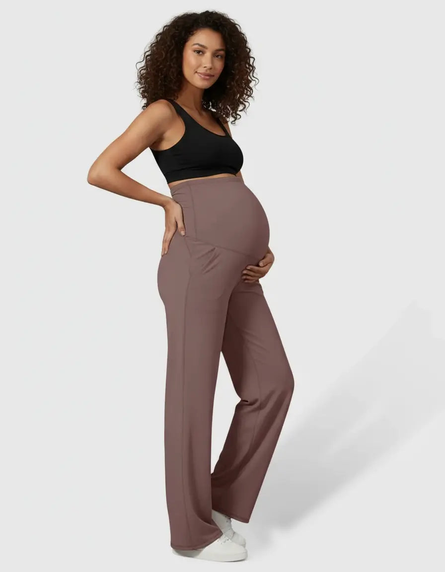 Pregnant woman in high-waist, straight-leg maternity pants in a soft mauve color.