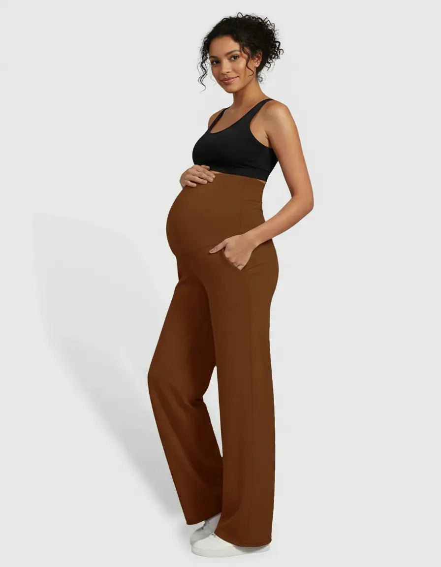 Pregnant woman in brown high-waist straight-leg maternity pants and a black sports bra.