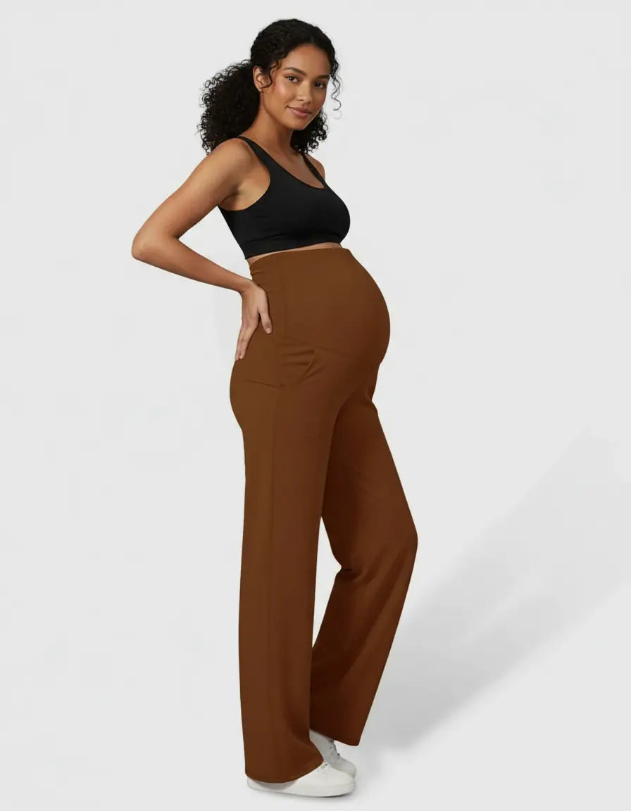 Pregnant woman in brown high-waist straight-leg maternity pants and a black crop top.