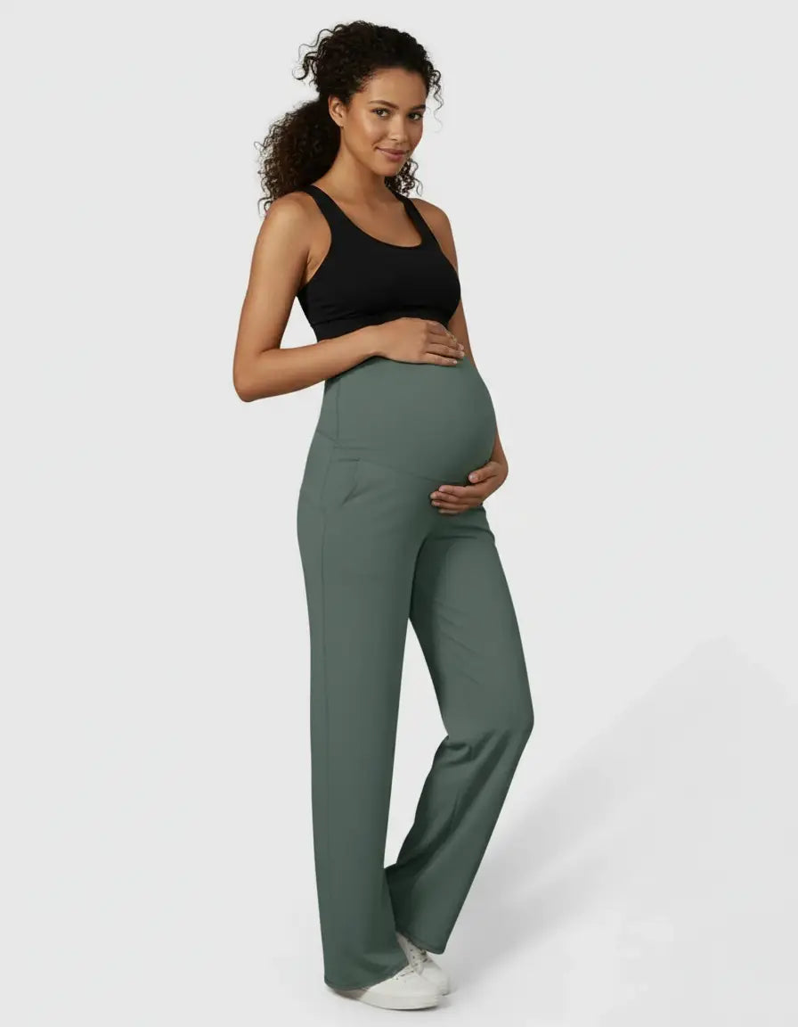 Pregnant woman in dark green high-waist straight-leg maternity pants and a black sports bra.