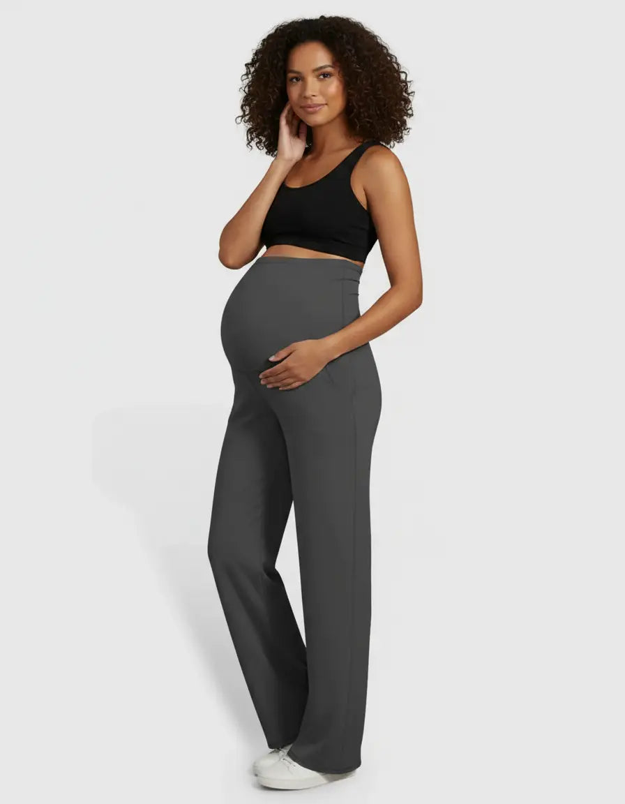 Pregnant woman in dark grey high-waist straight-leg maternity pants and a black bra.