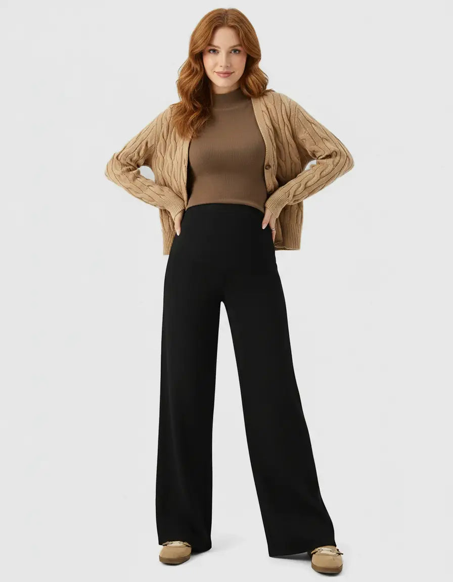 Woman wearing black high-waist wide-leg maternity wool pants, brown top, and beige cardigan.