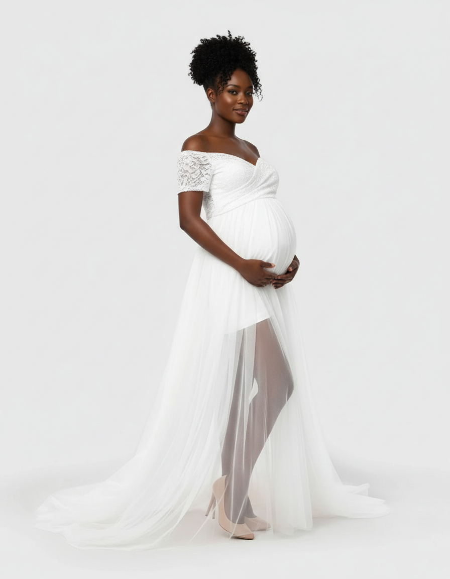 Maternity model in white lace & mesh off-shoulder gown with flowing tulle skirt.