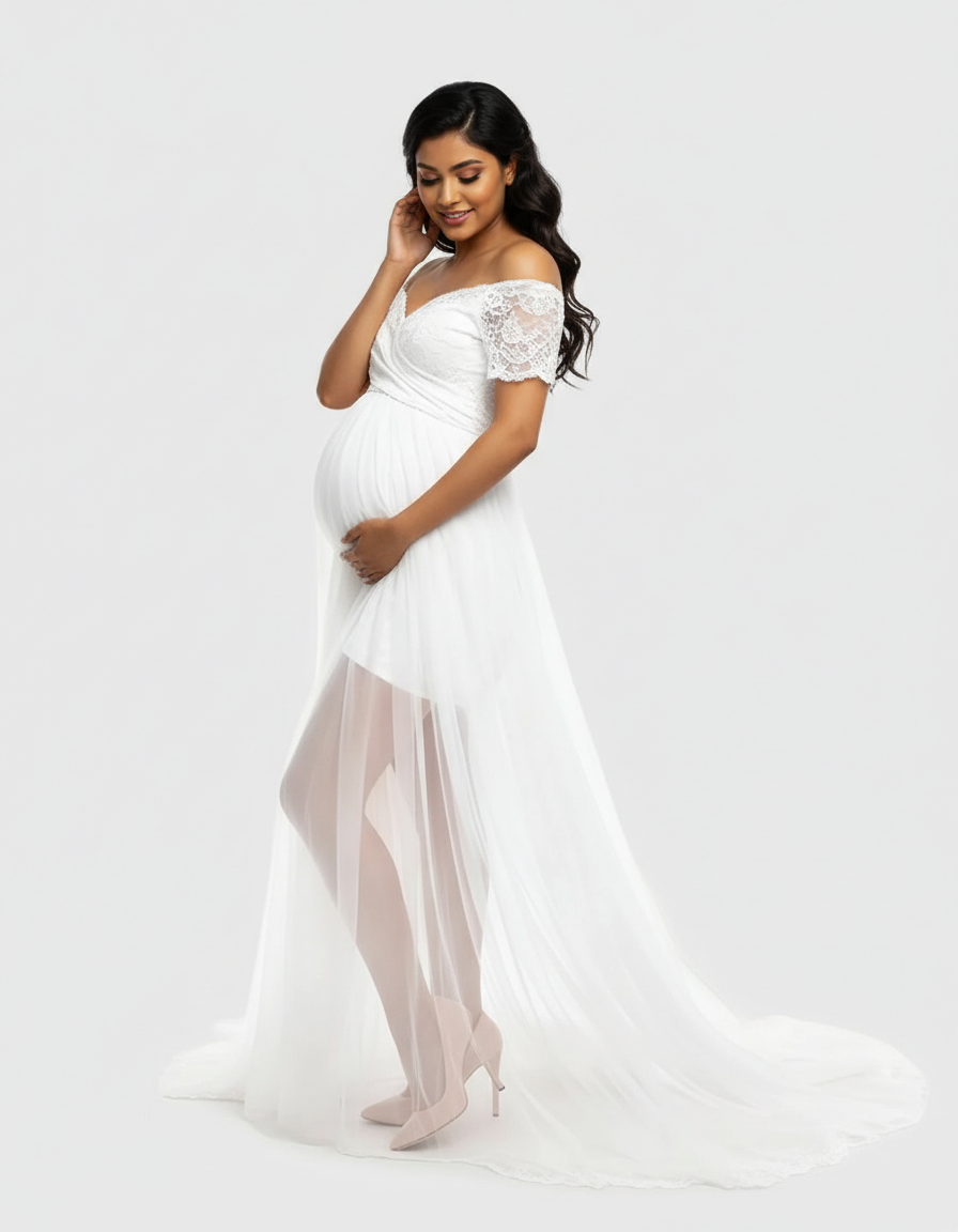 Pregnant woman in a white lace & mesh off-shoulder maternity gown with a flowing tulle skirt.