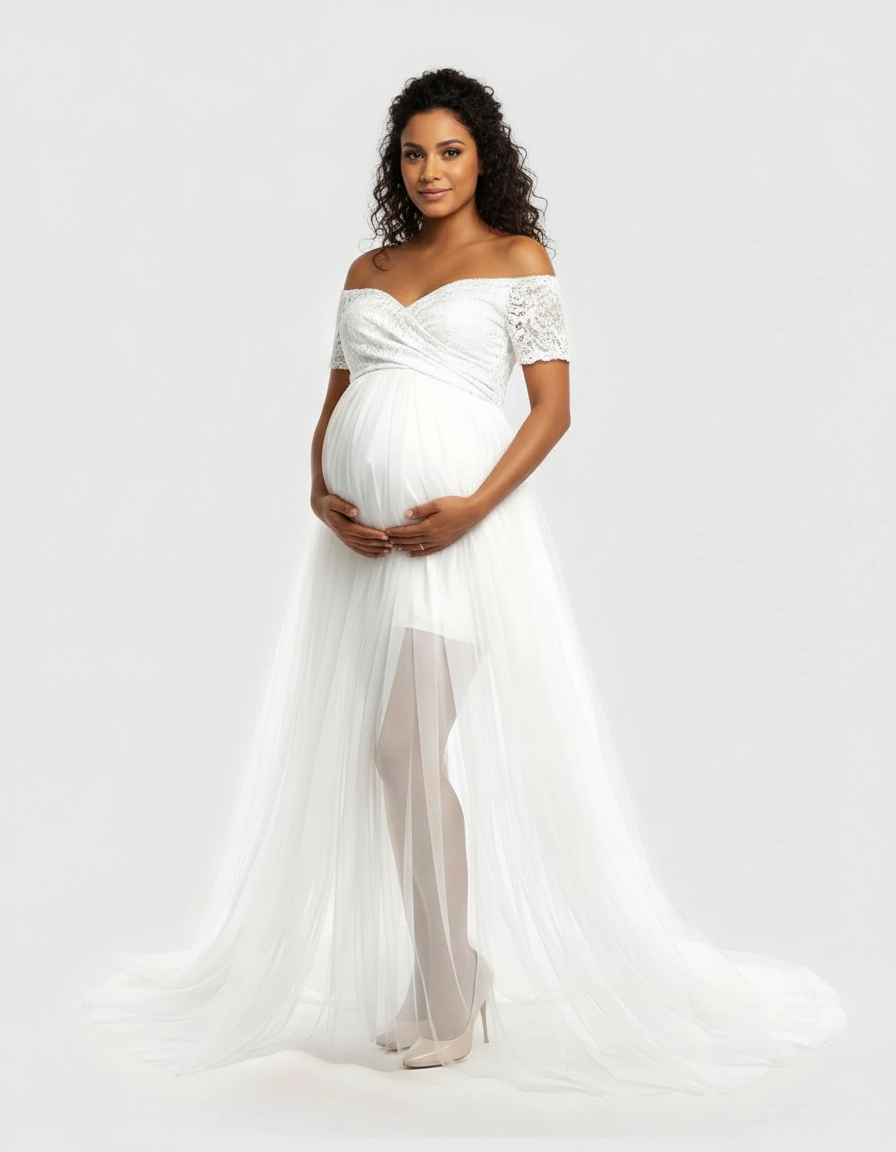 White lace & mesh off-shoulder maternity gown with flowing tulle skirt, worn by a smiling pregnant woman.