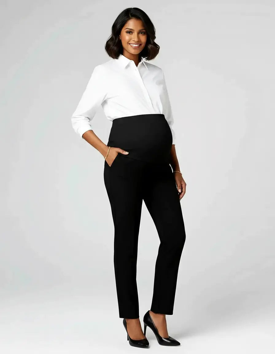 Smiling pregnant woman in black mid-waist straight-leg maternity work pants and a white button-up shirt.