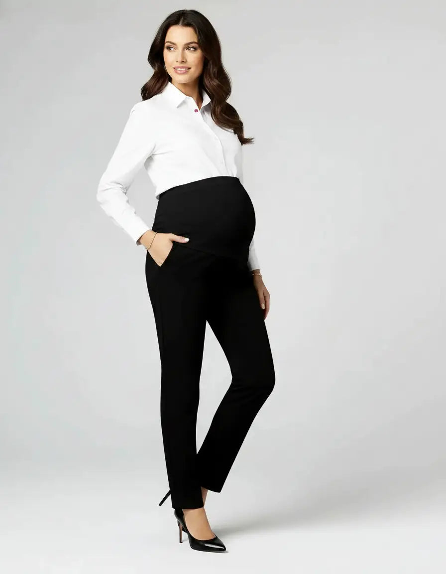 Smiling pregnant woman in black mid-waist straight-leg maternity work pants and white button-up shirt.