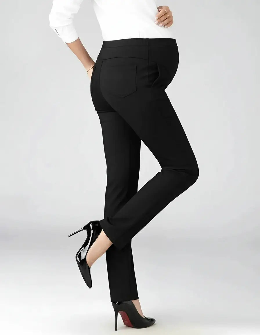 Black mid-waist straight-leg maternity work pants on a pregnant model, paired with high heels.