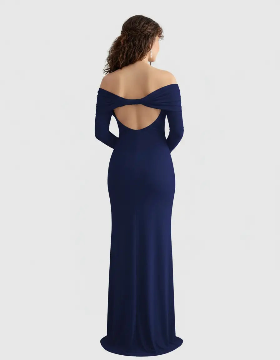 Woman from behind in a navy off-shoulder cross-back maternity gown with a bow detail.