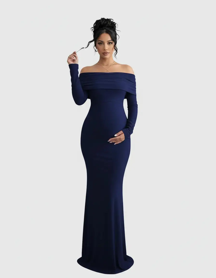 Pregnant woman in a navy off-shoulder, long-sleeve maternity gown with a flattering silhouette.