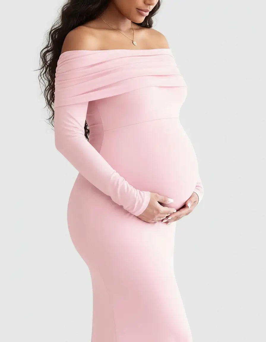 Maternity gown in soft pink, off-shoulder, long-sleeved, with a flattering silhouette for pregnancy.