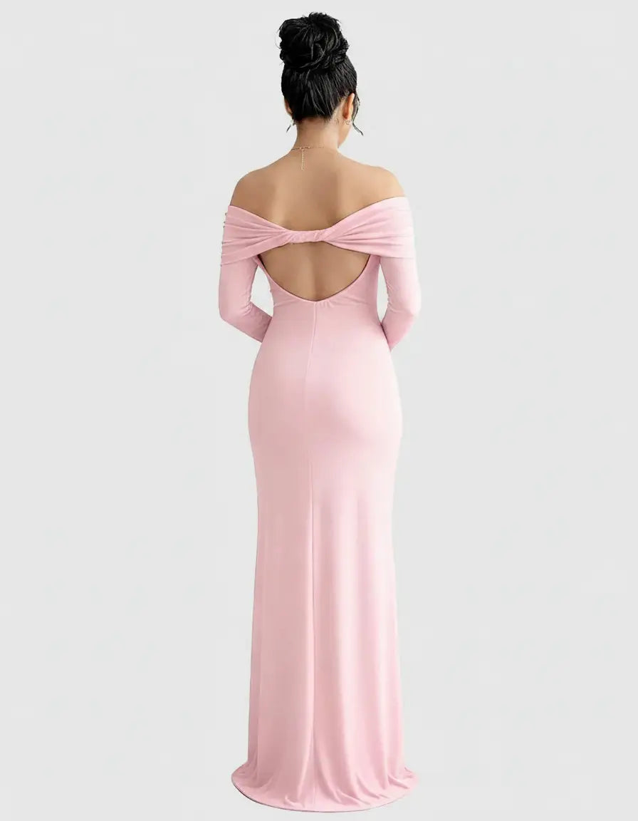 Pink off-shoulder cross-back maternity gown with long sleeves and a flowing skirt, viewed from the back.