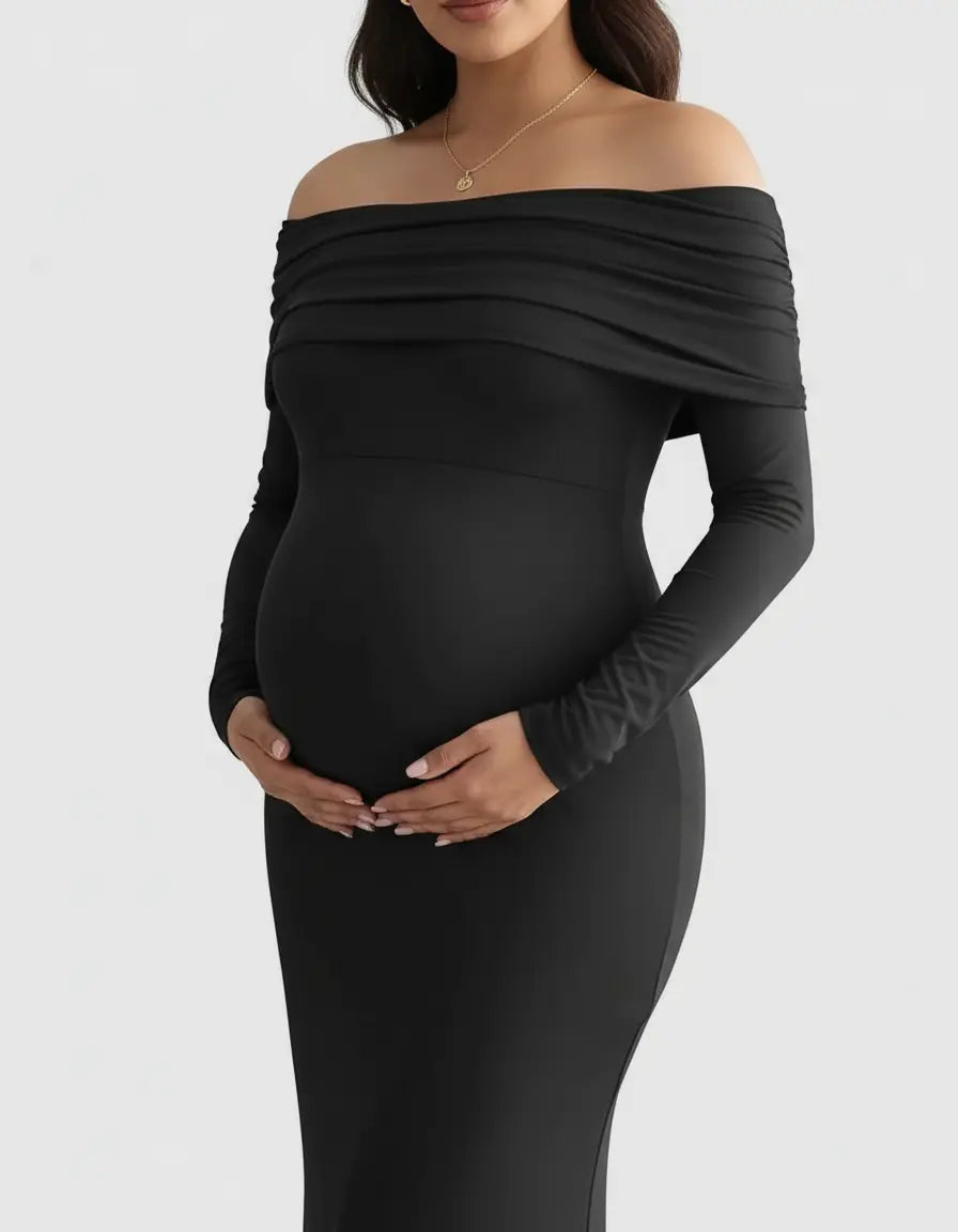 Black off-shoulder cross-back maternity gown with long sleeves, flattering a pregnant belly.