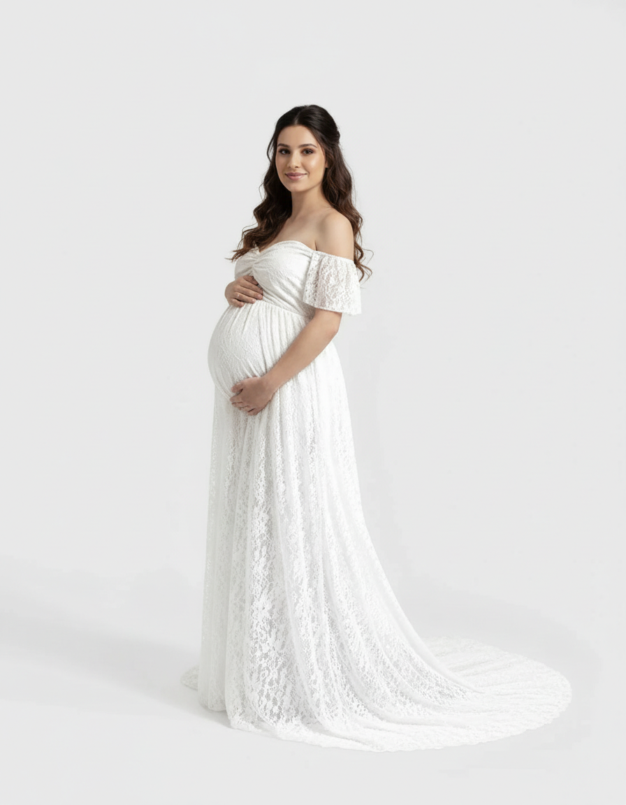 Pregnant woman in a white off-shoulder flowing lace maternity maxi dress with a long train.
