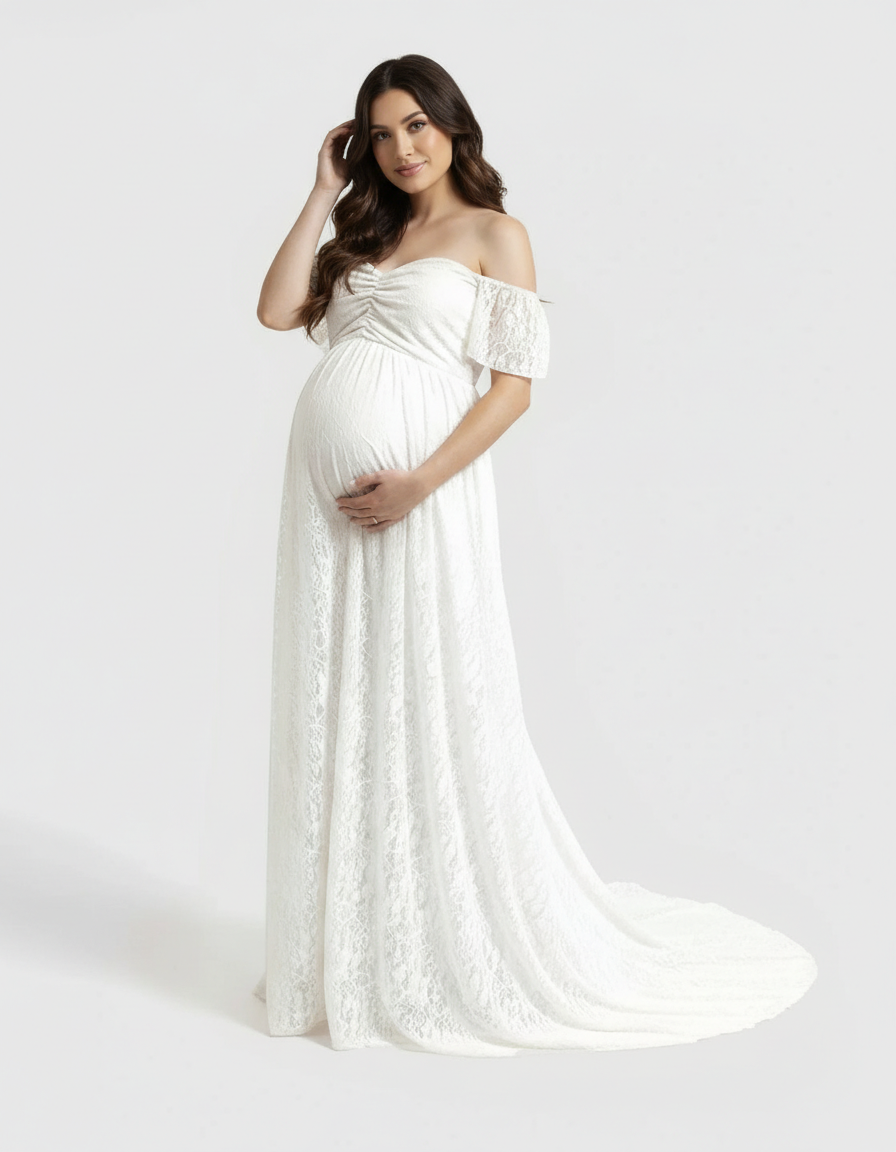 Pregnant woman in a white off-shoulder flowing lace maternity maxi dress with a long train.