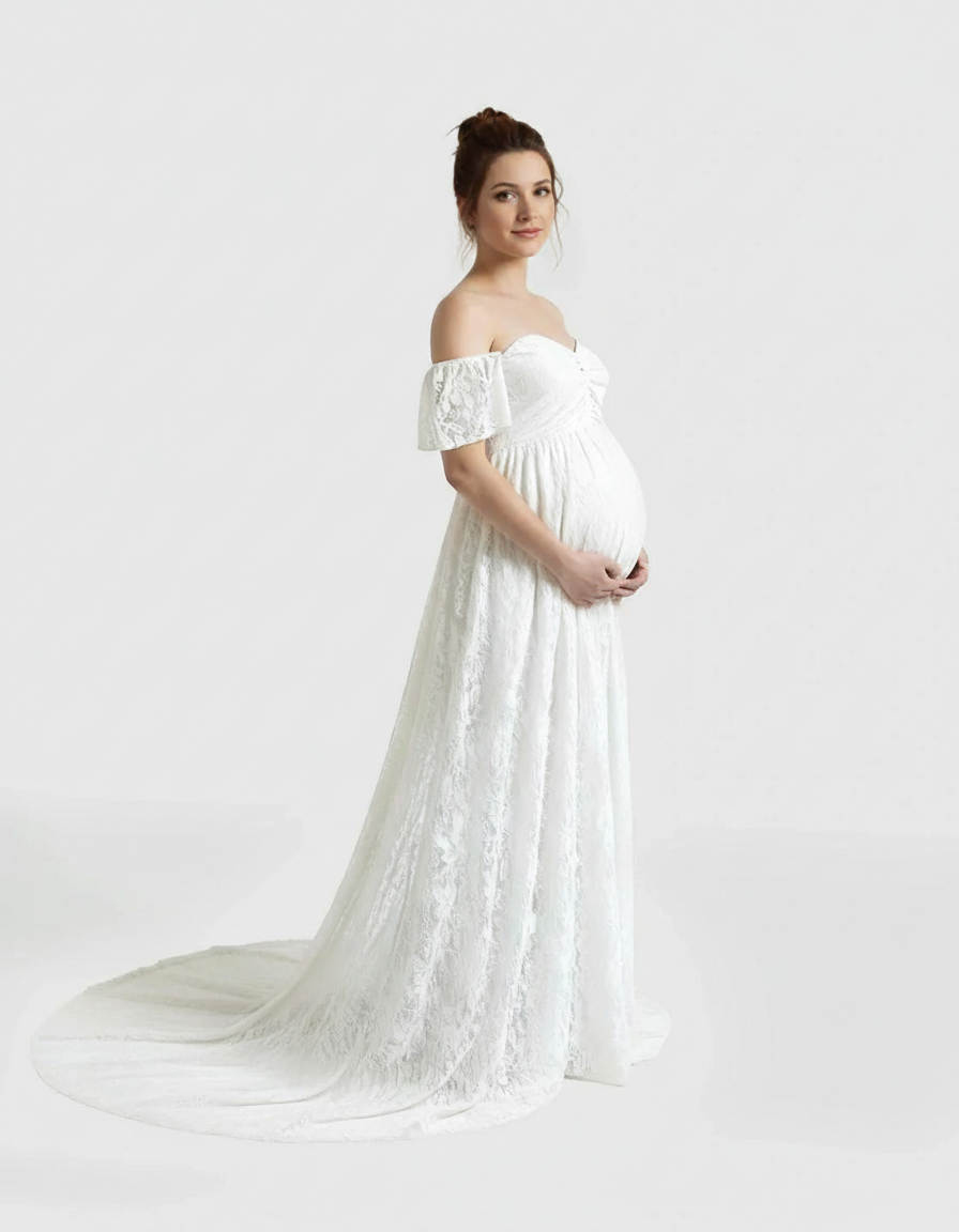Pregnant woman in a white off-shoulder flowing lace maternity maxi dress with a train.