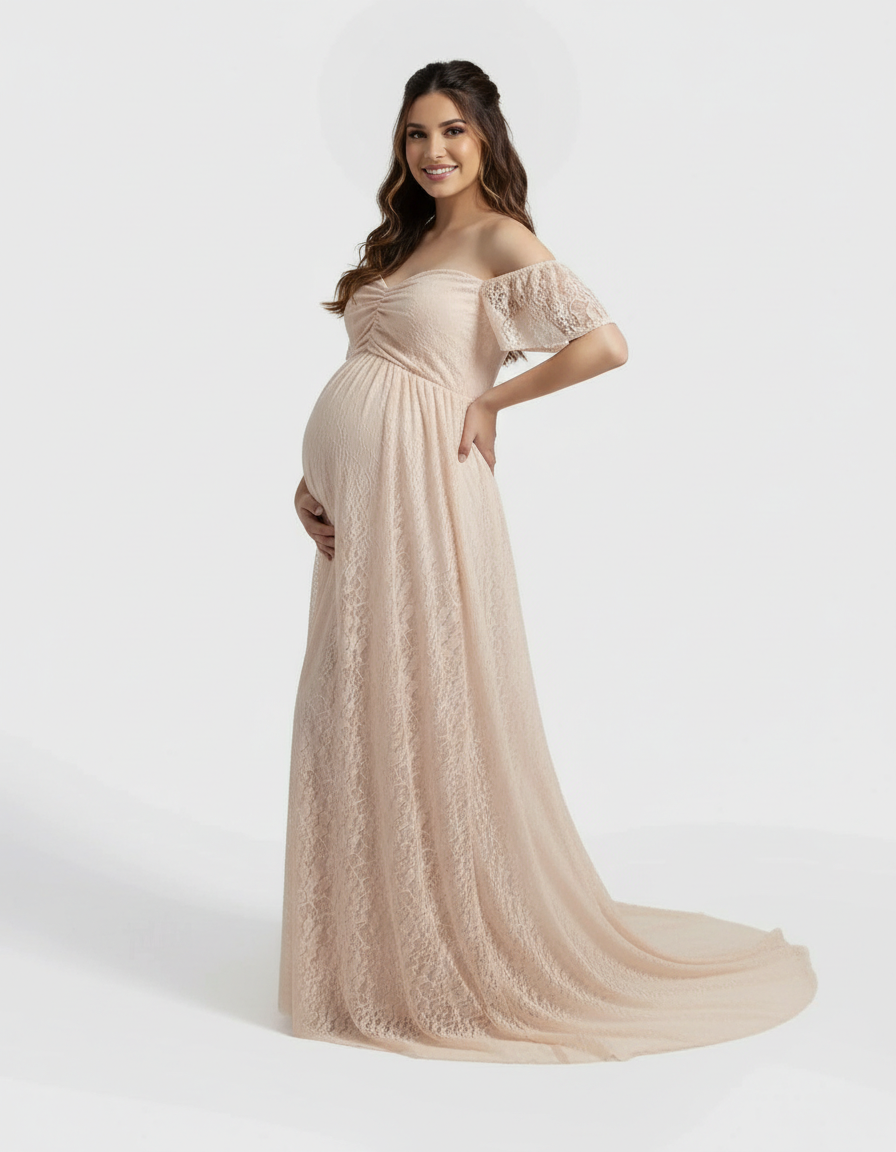 Smiling pregnant woman in a flowing, off-shoulder, peach lace maternity maxi dress.